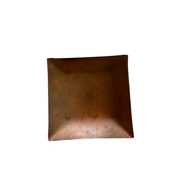 Small mid-century enamel-on-copper pin tray in a square diamond form. The glossy mustard yellow enamel surface features...