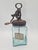 An original 3-liter hand-cranked butter churn, made of thick glass with a distinctive blue-green tint, equipped with a...