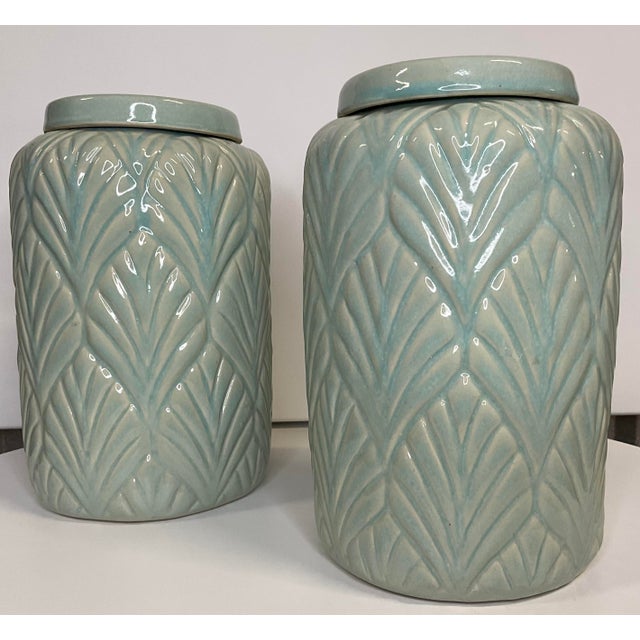 Ceramic ginger jars feature a celadon glaze and Ginko leaf motif. Ginko leaf design around entire jar. Flat 1 inch high...