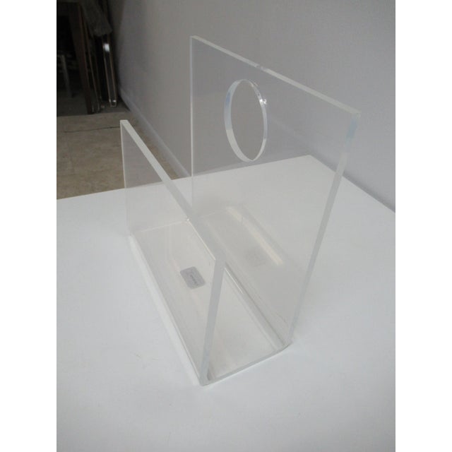 A vintage Mid-Century lucite magazine rack. Some scratches and scuff marks.