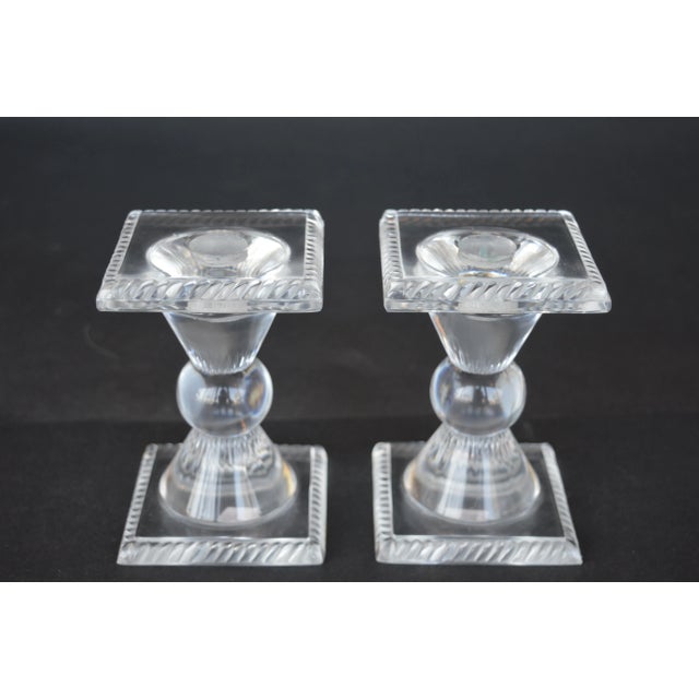 Set of four female Lalique figurines with a pair of Lalique candle sticks.