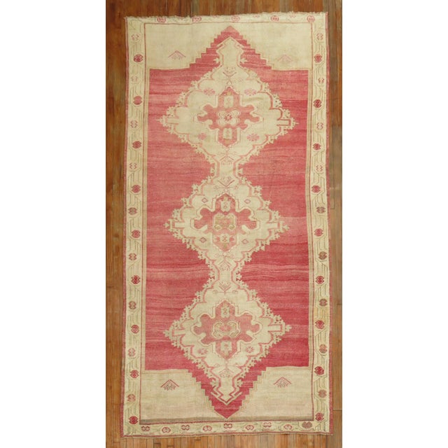 A gallery size mid 20th century Turkish Rug with 3 large medallions on a bright pinky red field Details rug no. 31391 size...