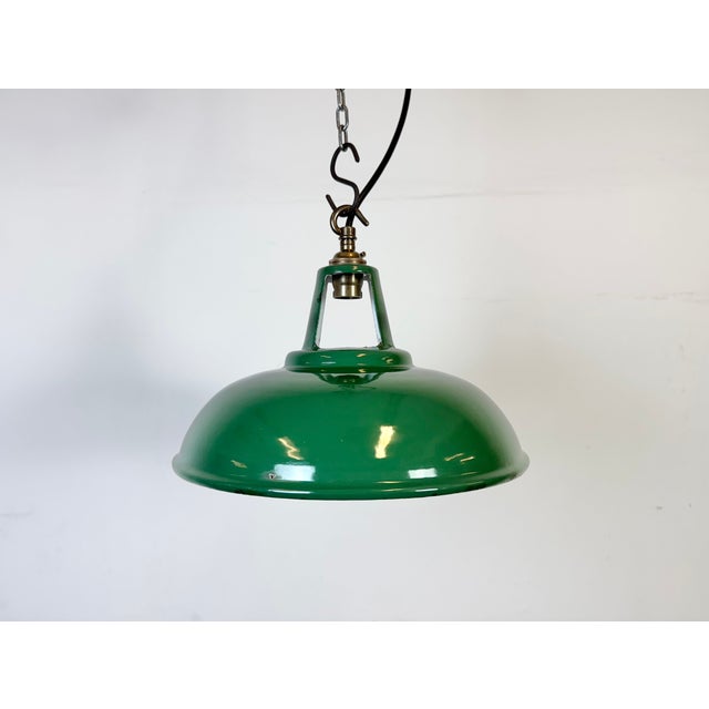 Industrial green enamel factory pendant light made in United Kingdom during the 1960s. White enamel inside the shade....