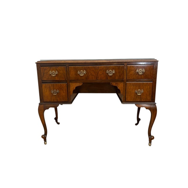 This elegant antique writing desk showcases a sophisticated design that combines functionality with timeless...