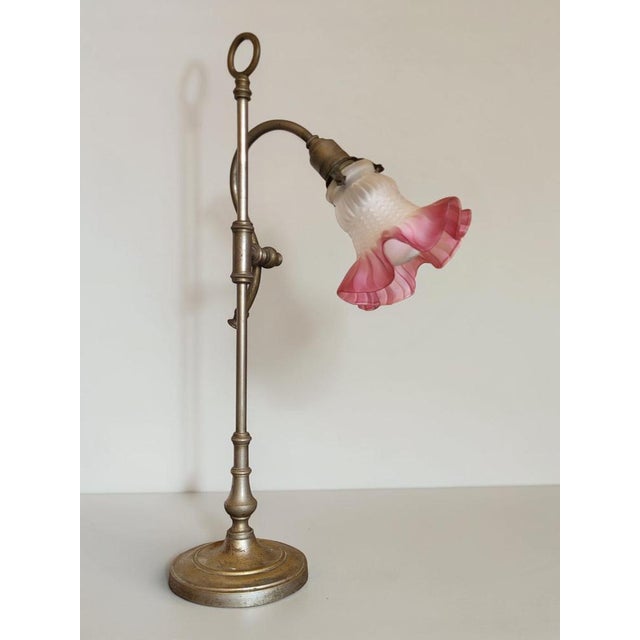 Gooseneck desk lamp dating from the 1920s-30s. The neck tilts forward and backward and moves up and down using a piston...