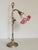 Gooseneck desk lamp dating from the 1920s-30s. The neck tilts forward and backward and moves up and down using a piston...