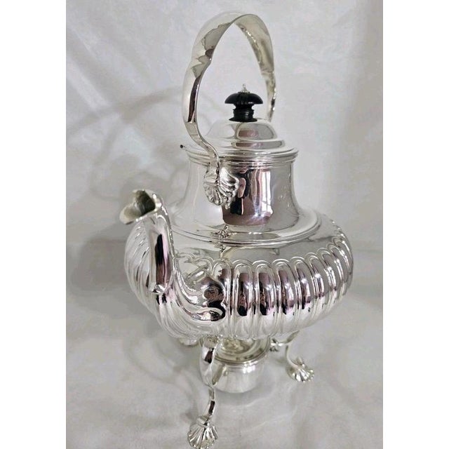 A fine elizabeth ii sterling silver spirit kettle on stand, hallmarked london 1975, combining traditional english...