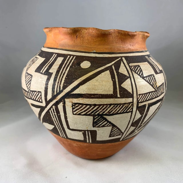 A thin walled and delicately decorated with an intricate geometric design Olla in the traditional style of the Acoma...