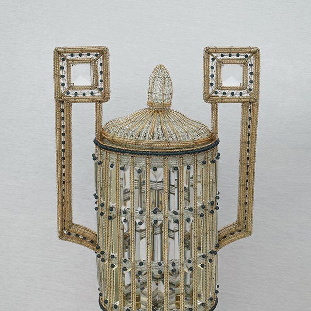 Construction in glass beads, faceted glass and metal containers. The pair of Art Deco style lamps features a cylindrical...