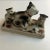 Vintage glazed ceramic family of mother cat with three kittens. Charming playful representation with decorative leaves...