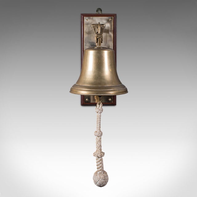 This is a vintage school dinner bell. An English, brass and mahogany mounted playground ringer, dating to the mid 20th...