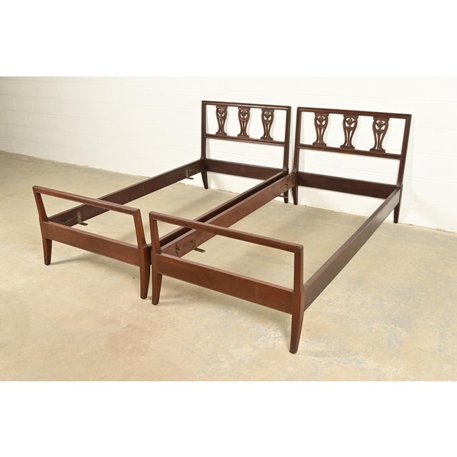 A gorgeous pair of antique Italian or Neoclassical style carved walnut twin size beds In the manner of Baker Furniture...