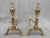 A pair of diminutive polished brass andirons. Turned elements at the top ending in ornate arched legs. Very good vintage...