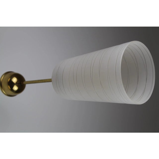 Frosted etched glass, brass mount, socket E27. This piece is attributed to the mentioned designer/maker. It has no...