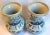 This is a pair of Indigo and Bone White Chinoiserie vases. These vases are hand made with a "foot stomp" process and hand...