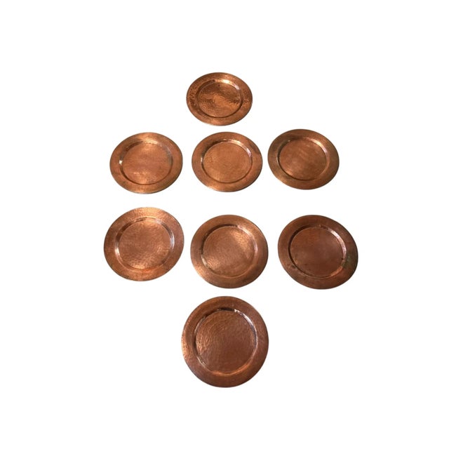 Wonderful group of eight hand hammered copper charger plates. These plates measure 12 inches across. Each plate has been...