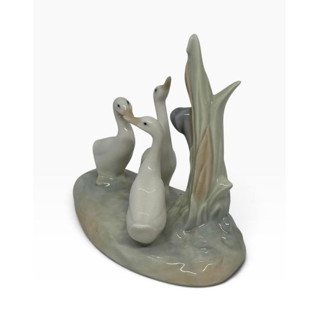 Handcrafted glossy porcelain group of three white ducks/geese among tall reeds, Valencia, Spain. Backstamped NAO by LLADRÓ...
