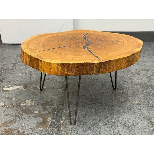 Design Plus Gallery presents a Live Edge Wood Slab Coffee Table. The tabletop is formed from a thick cross-section of...