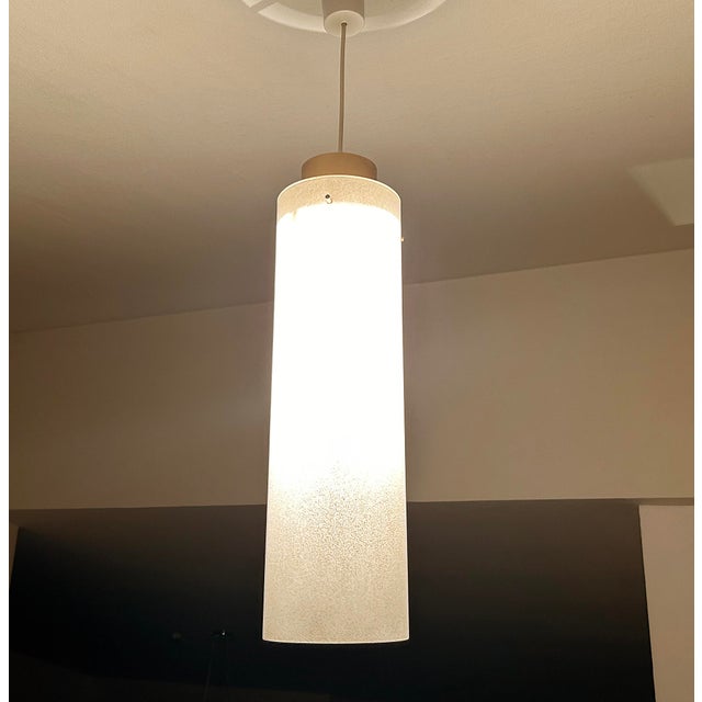 Very large mid century pendant light featuring a cylindrical glass shade with frosted pattern, bronze enameled holder /...