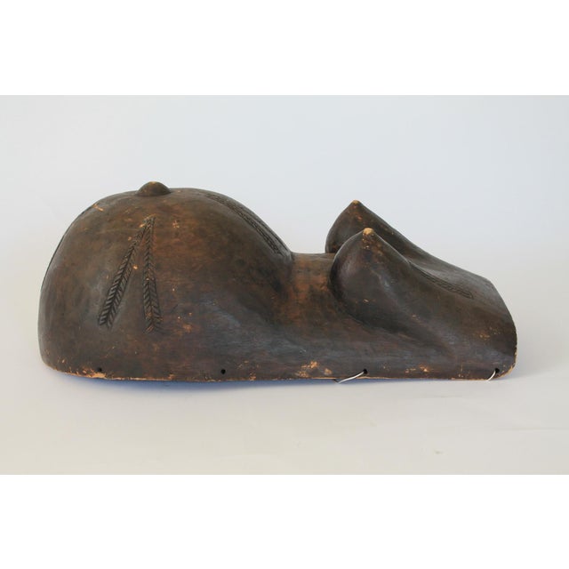 Antique wooden belly or fertility mask, likely crafted by the Makonde people of Tanzania and Mozambique. Depicts a...