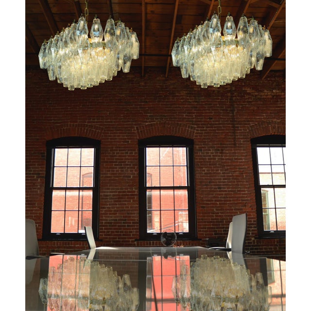 Pair Elegant Italian chandelier made from 56 beautiful Murano trasparent glasses “poliedri”. Structure in gold and brass...
