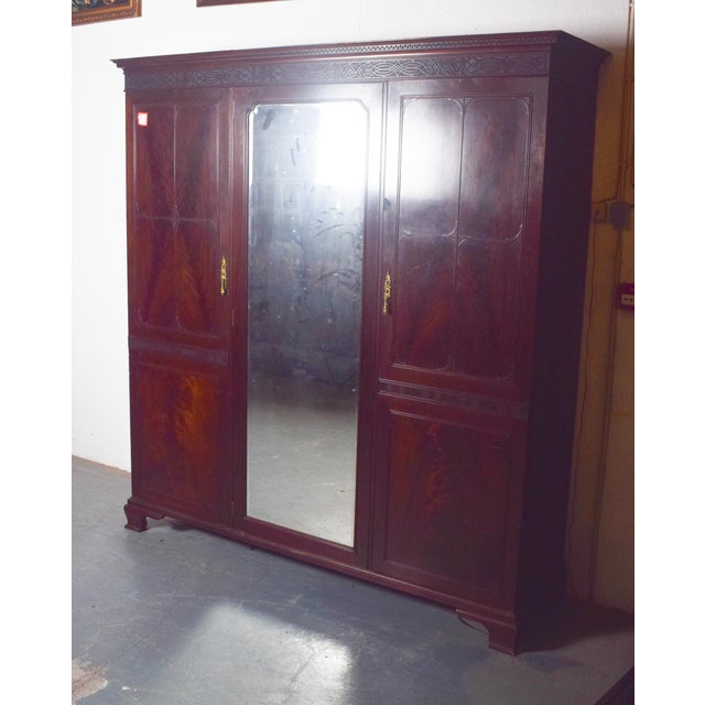 This elegant English wardrobe exudes timeless charm and practical functionality. Crafted from richly toned mahogany, it...