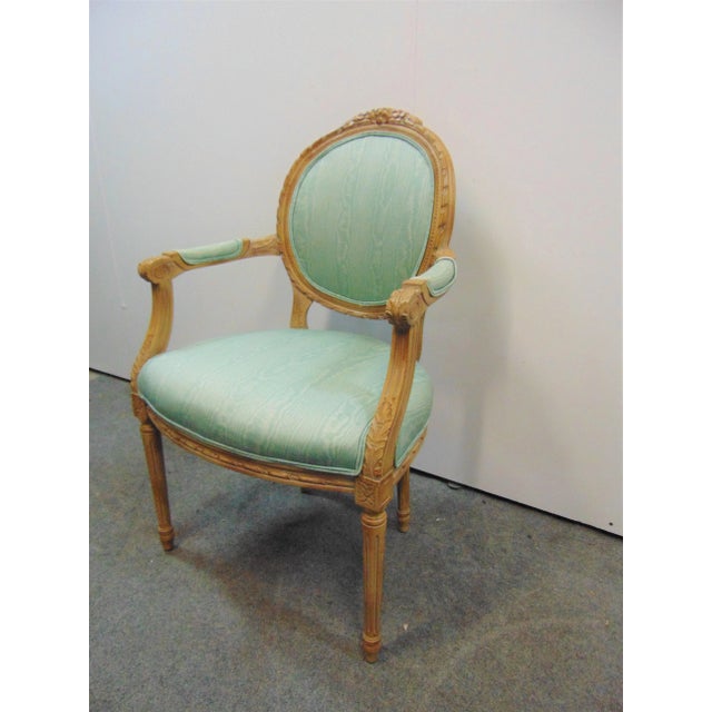 Louis XVI Style Upholstered Armchair, carved frame with floral decoration, green satin upholstery