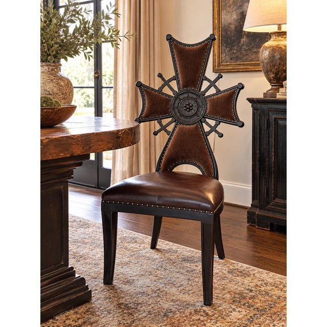 A striking Iron Cross accent chair in the Gothic Revival taste. The tall cross-form back is upholstered in chocolate brown...