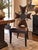 A striking Iron Cross accent chair in the Gothic Revival taste. The tall cross-form back is upholstered in chocolate brown...