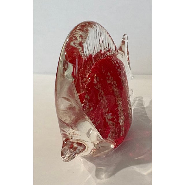 A " Sommerso" teqnique, where a red interlayer is encapsulated in clear glass with gold leaf inclusion stripes creates...