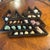 A striking triangular wooden display case showcasing a curated collection of colorful natural seashells. Designed for both...