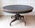 A striking Swedish Empire oval center table, circa 1830, distinguished by its bold architectural form and richly carved...