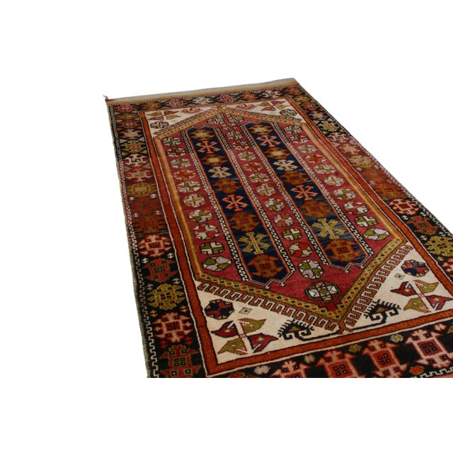 Made with hand-knotted wool and originating between 1900-1910, this antique rug is derivative of an Anatolian transitional...