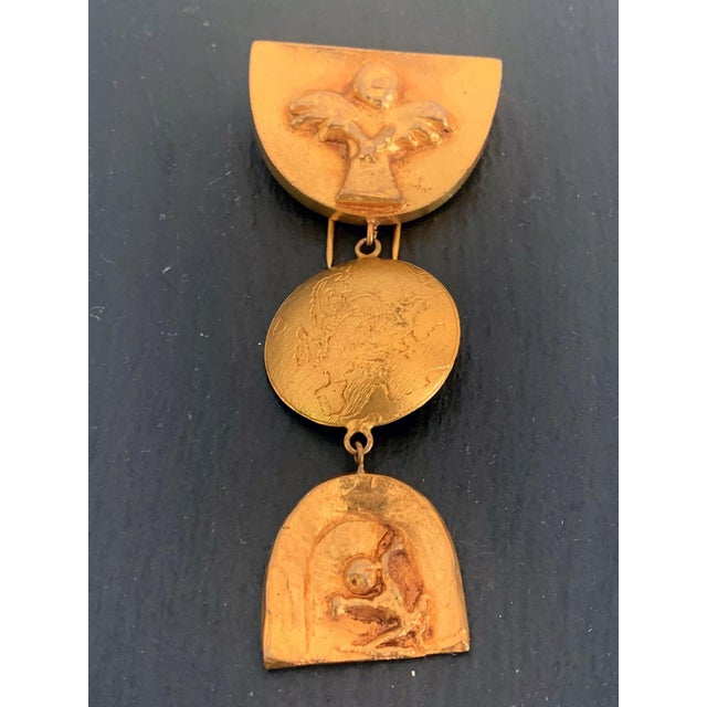 A hanging articulate three-piece gilt bronze brooch "Purgatoire" also known as "Le Ciel, la Terre, et l'Enfer." by Line...