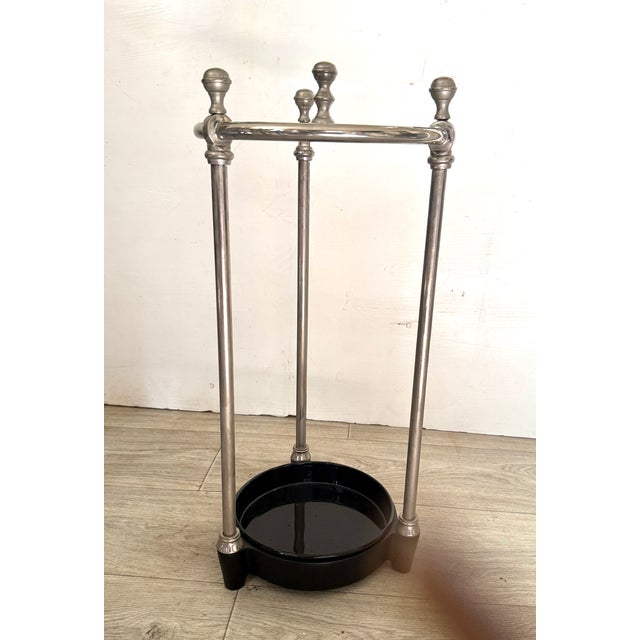 Eichholtz Artman umbrella stand. Its elegant nickel-plated frame consists of three sections, offering space to hold up to...