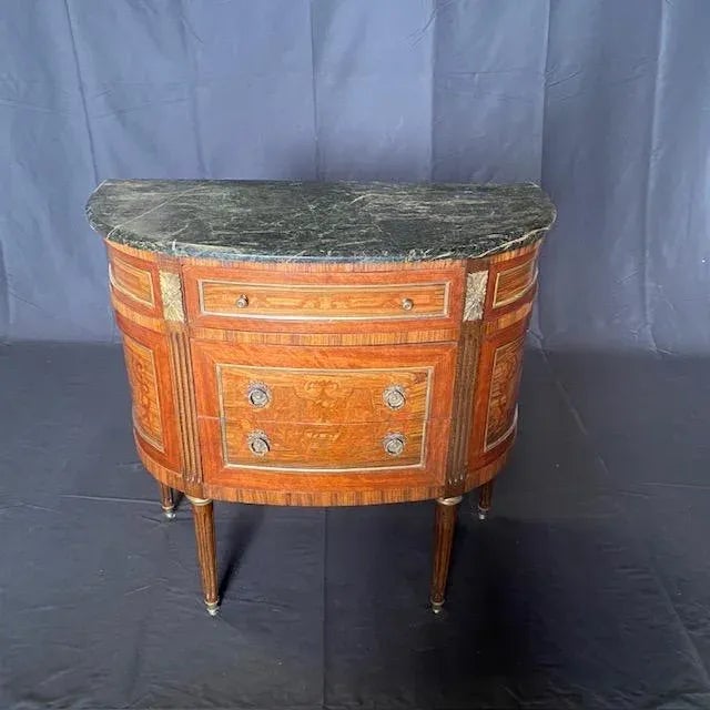 Elegant French Louis XVI demilune marble top commode or console is a remarkable work of art: it features a fully curved...