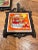 Vintage trivet for decor, wall hanging, or kitchen use. Most likely A Lorrie Design by identifying the tile manufacturer...
