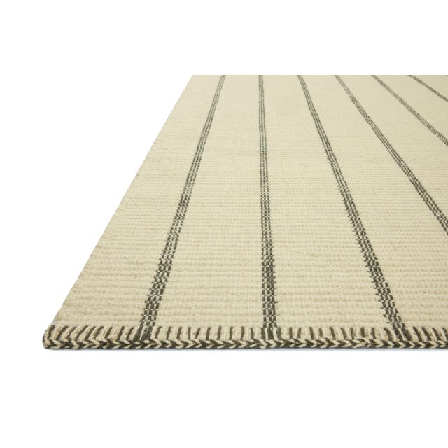 The Harlan Collection by Amber Lewis x Loloi is a classic striped flatweave area rug in the interior designer’s signature...