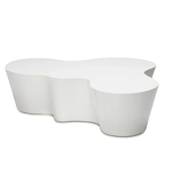 The organic shape of this cocktail table is a pleasing accent in any modern setting. Each hand-finished table is...