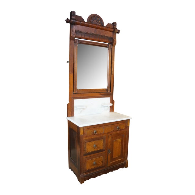 An antique Eastlake Victorian walnut washstand with a matching swivel mirror tower, dating back to the late 19th century....