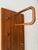 Three slender elements side by side, crafted from the same warm teak. It is precisely as a complete composition that this...