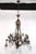 Neo Rococo style cast bronze chandelier with scrollwork along the arms, griffins on the end of the arms, and a salamander...