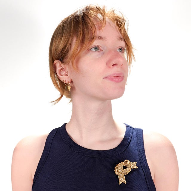 A fine Mid-Century Modern brooch. In 18 karat yellow & white gold. By Cartier. In the form of a ribbon or folded scarf....