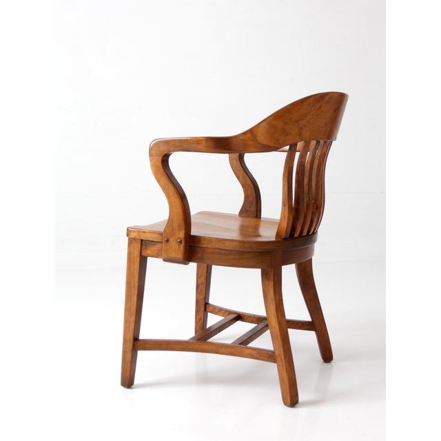 Early 20th-century Windsor captain's chair crafted with the timeless character and enduring appeal of traditional American...