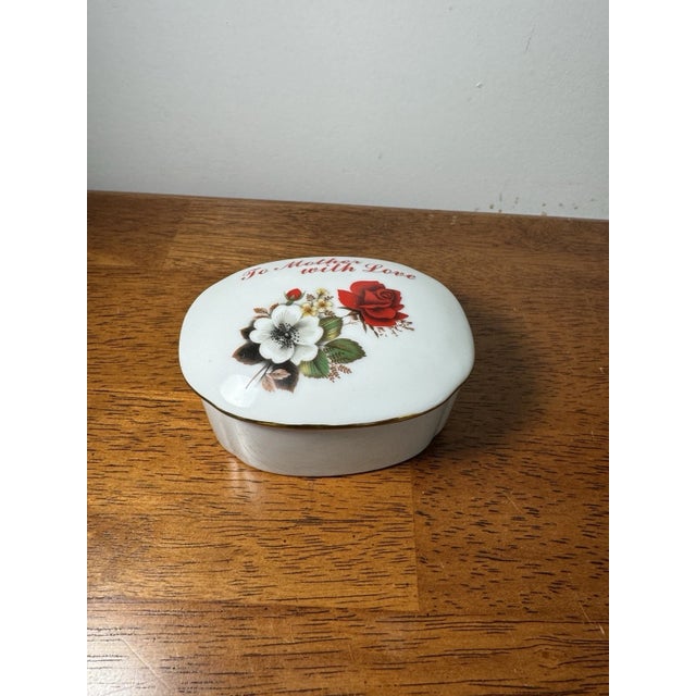 Vintage OMC Japan porcelain trinket box featuring a floral “To Mother With Love” design with gold trim and removable lid....