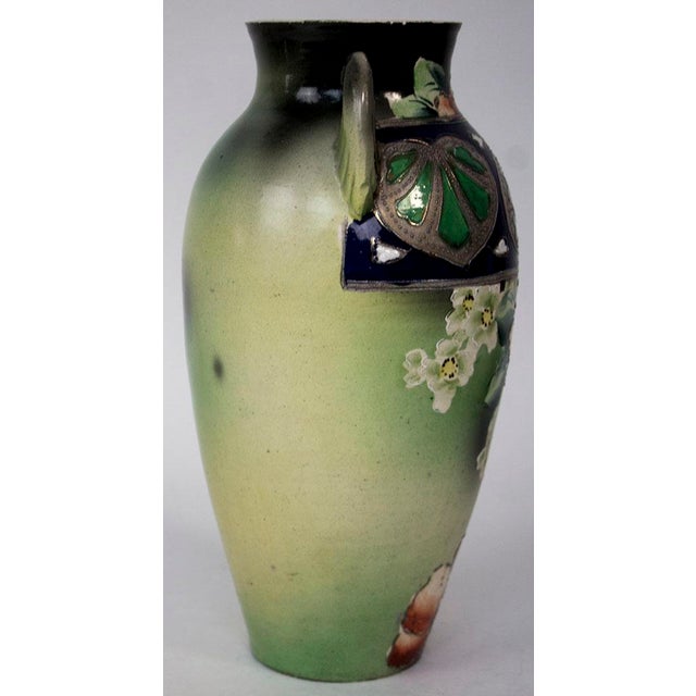 Antique Nippon vase decorated with beautifully hand painted flowers. Marked on bottom ESO Hand Painted Nippon. ESO denotes...