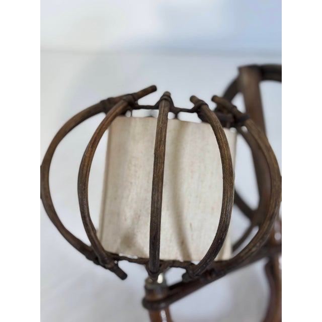 Wall sconce by French designer Louis Sognot, emblematic of the organic modernism of the 1950s. A curved rattan structure...