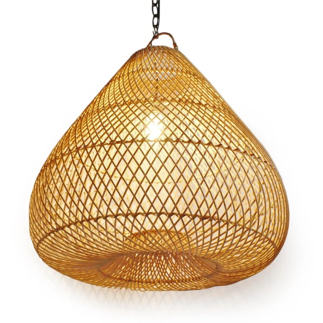 Classic natural rattan Batu drop pendant made from handcrafted traditional weaving techniques with iron wire framing. Each...