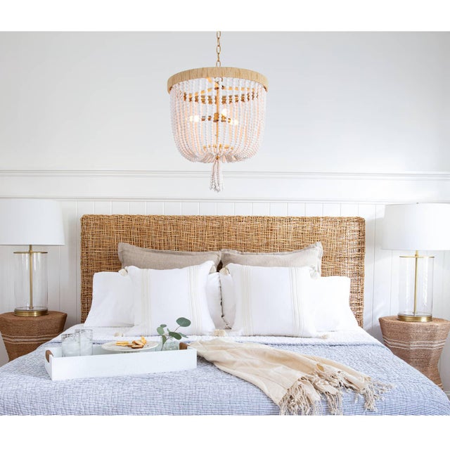 Milos beaded chandelier combines natural tones and textures for an eclectic and layered fixture. Its rattan-wrapped frame...