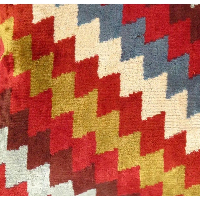 Bohemian silk velvet ikat pillow with vibrant colors of red, beige and blue. Super hand soft. Pillow has a zipper for...